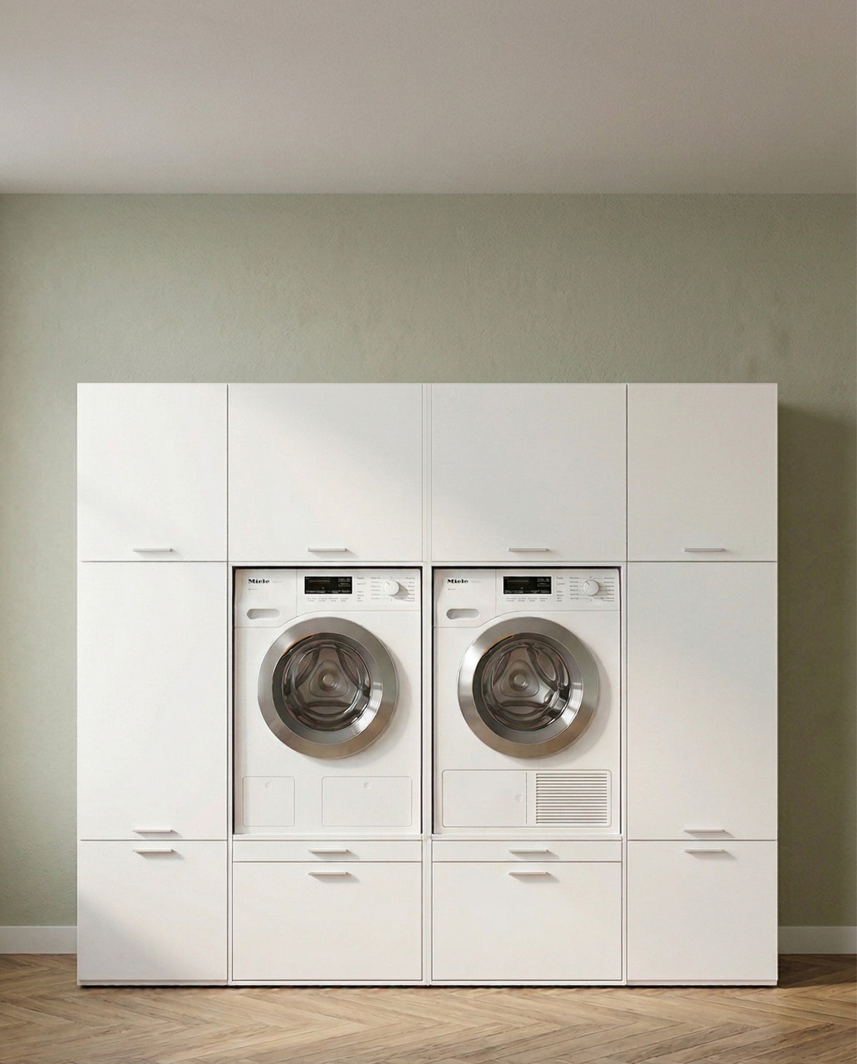 White built-in laundry cabinet set with front-load washer and dryer and storage compartments.