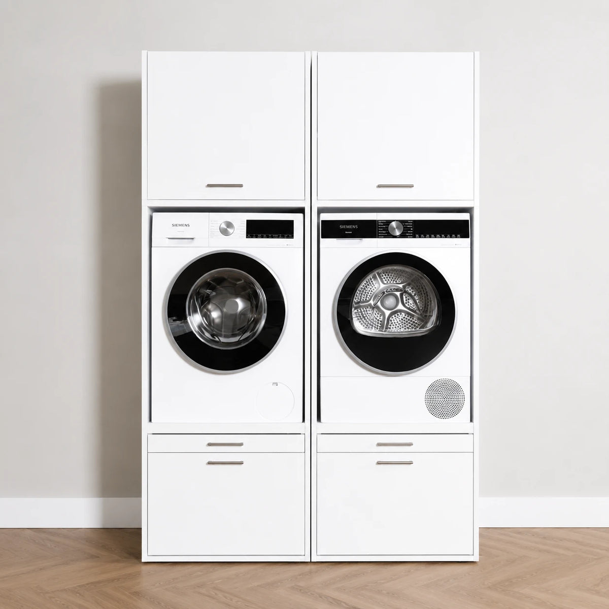 White modern stacked washer and dryer units with digital displays and storage cabinets above and below.