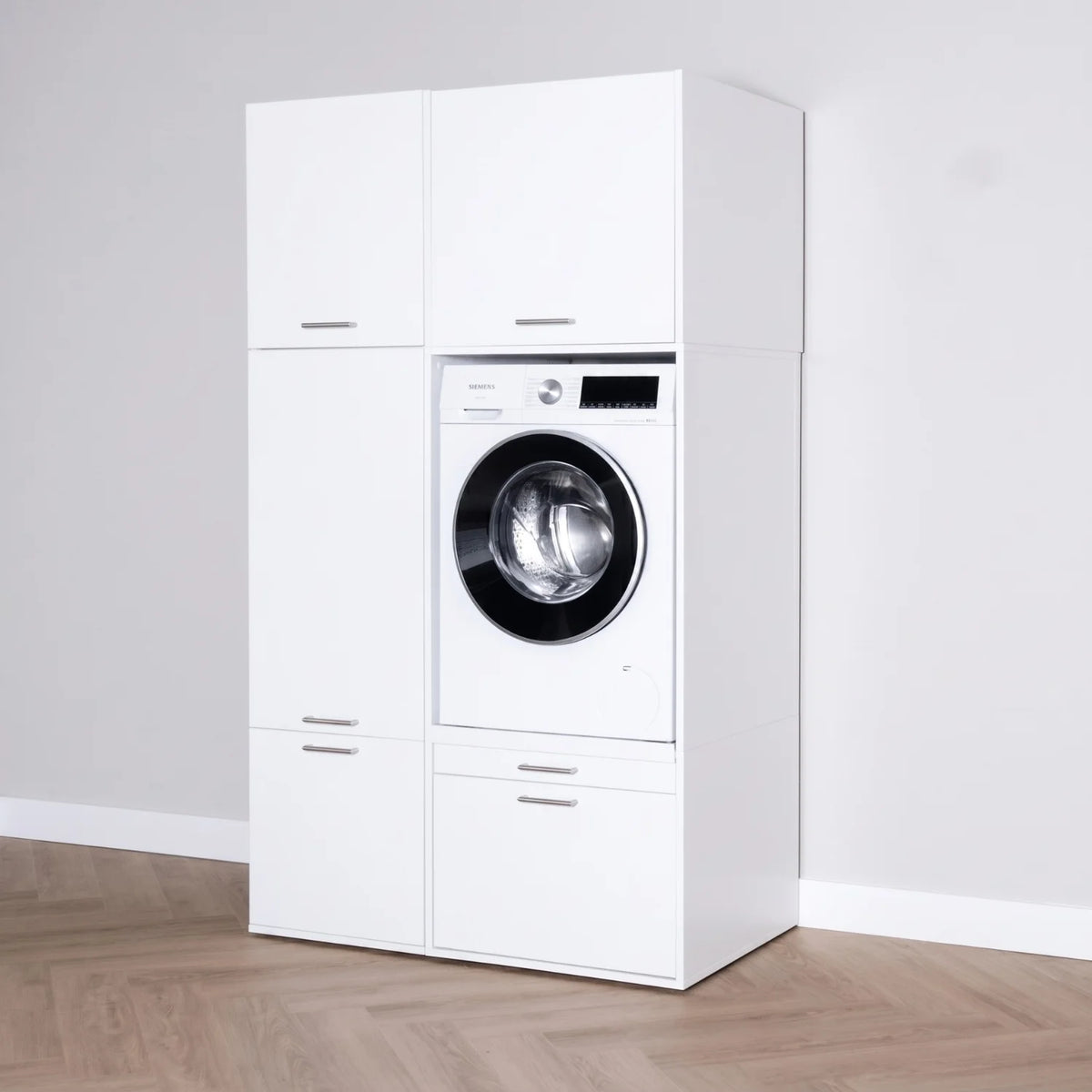 White modular laundry cabinet set with integrated front-loading washing machine and silver handles.